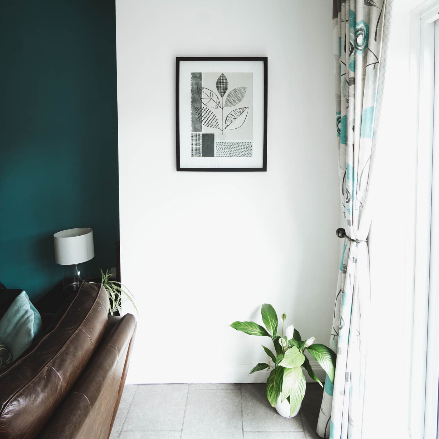 Interior of house living area showing well lit space with framed image hanging on wall